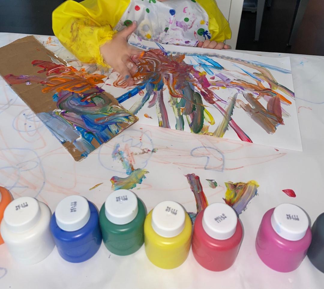child painting with paints