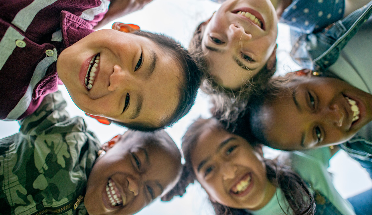 Multi-Ethnic Group of Elementary Students Looking Down